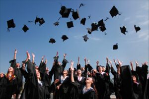graduates throwing caps - apply investment thinking in life